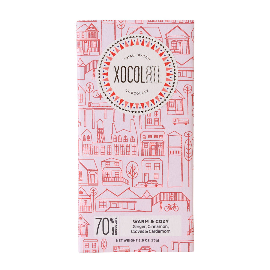 Xocolatl Chocolate bar in a light pink wrapper called Warm and Cozy, a 70% dark chocolate made with ginger, cinnamon, cloves & cardamom.