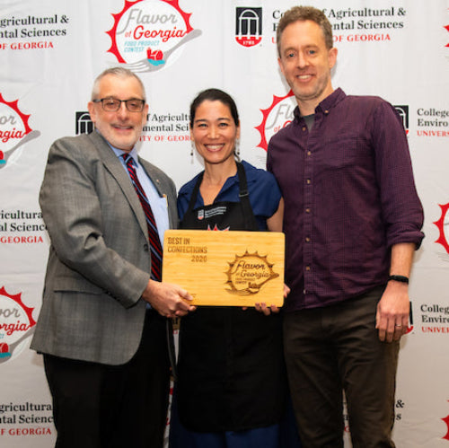 Elaine and Matt receiving the Best in Confections award plaque from a judge at the Flavor of Georgia Annual Award Contest.