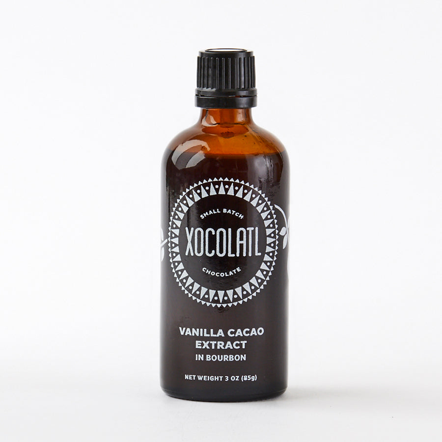 An amber brown glass bottle with a black top on a white background. The bottle says Xocolatl Chocolate Vanilla Cacao Extract In Bourbon.